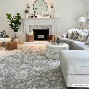 Living room scene with a gray Kanimbla Thick Luxe Avant Garde Rug, fireplace, and light gray sectional sofa. Roomscene-Rectangle