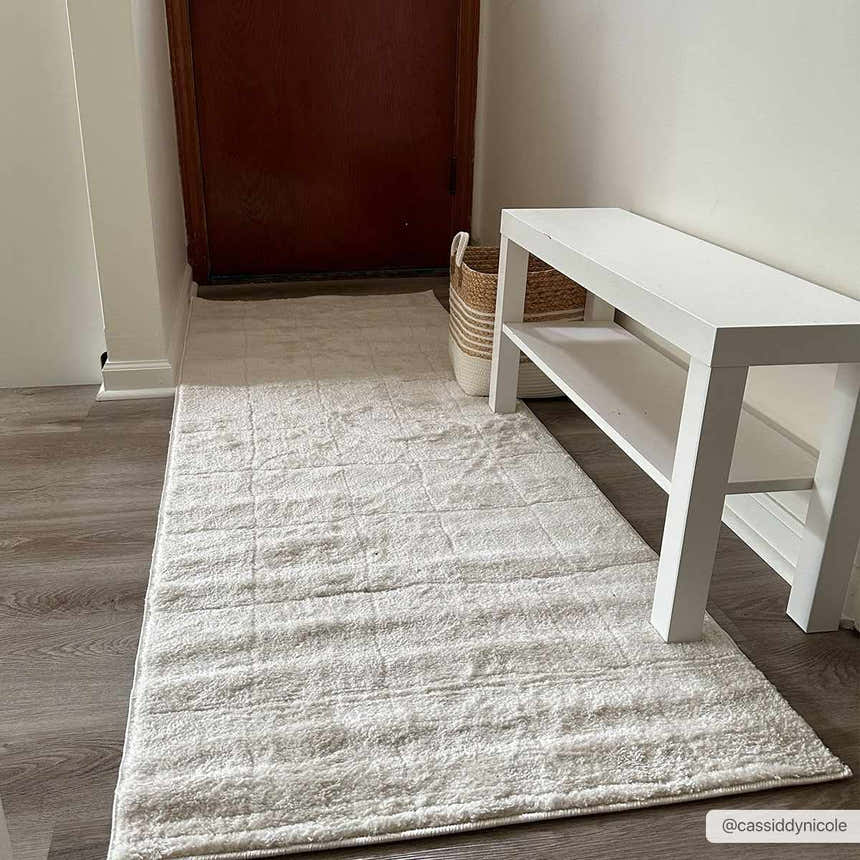 Entryway with a Keanu Ivory Area Rug runner, white bench, wood floors, and neutral decor. Roomscene-Runner