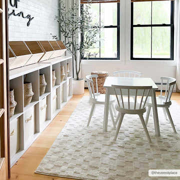 Kids room scene with white table and chairs on Keesa Checkered Area Rug. Ivory rug in a bright, contemporary space. Roomscene-Rectangle