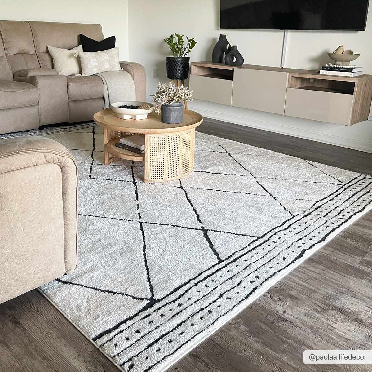 Living room scene with a Keone Black & White rug, beige sofa, wood coffee table, and floating media console. Modern farmhouse style. Roomscene-Rectangle