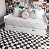 Teen bedroom with a white daybed on a Kieu Black & White Checkered Shag Rug. Collage wall. Roomscene-Rectangle