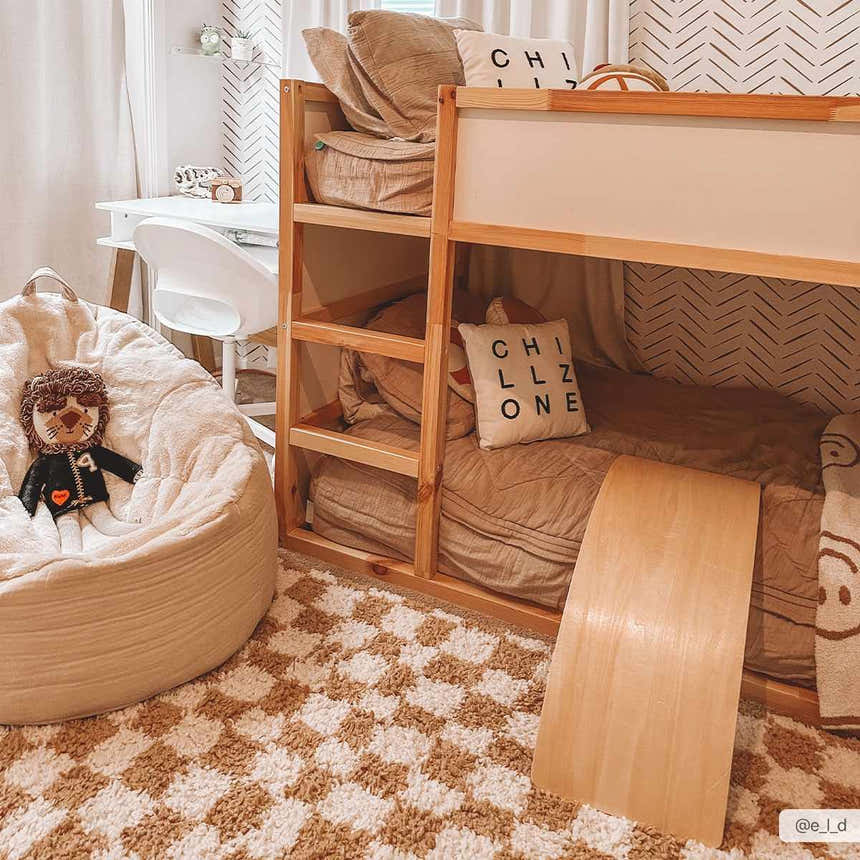 Kids room with a Kieu Mustard & Ivory Checkered Area Rug, bunk bed, beanbag chair, and white desk. Warm, inviting, and playful. Roomscene-Rectangle
