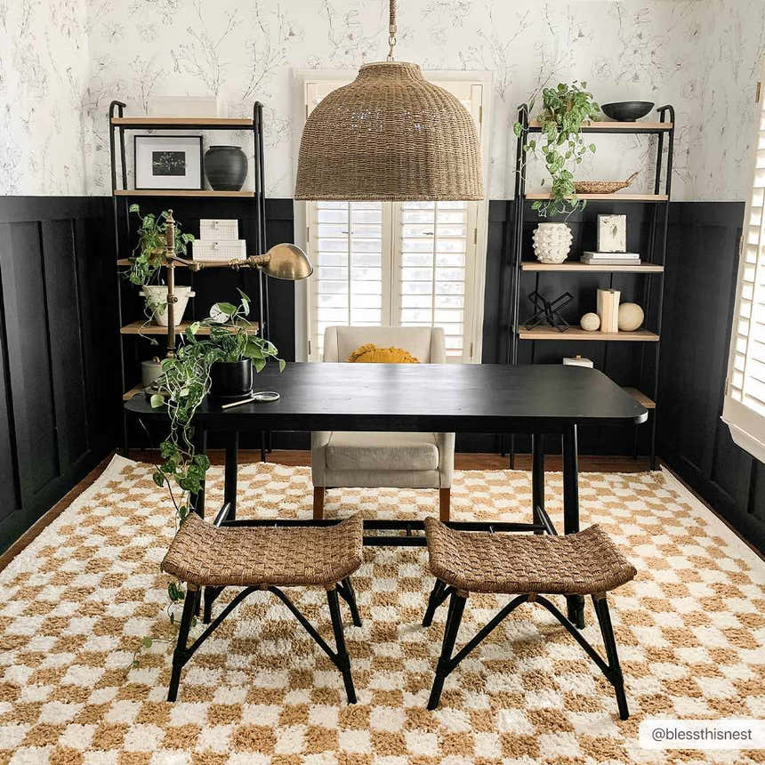 Home office with black desk on Kieu Mustard & Ivory Checkered Area Rug. Bohemian style with woven stools and shelving. Roomscene-Rectangle