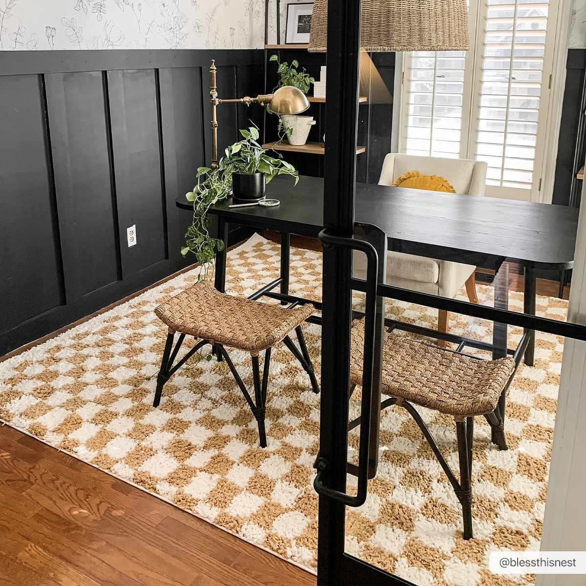 Home office with black desk and Kieu Mustard & Ivory Checkered Area Rug. Woven stools and black accent wall. Roomscene-Rectangle