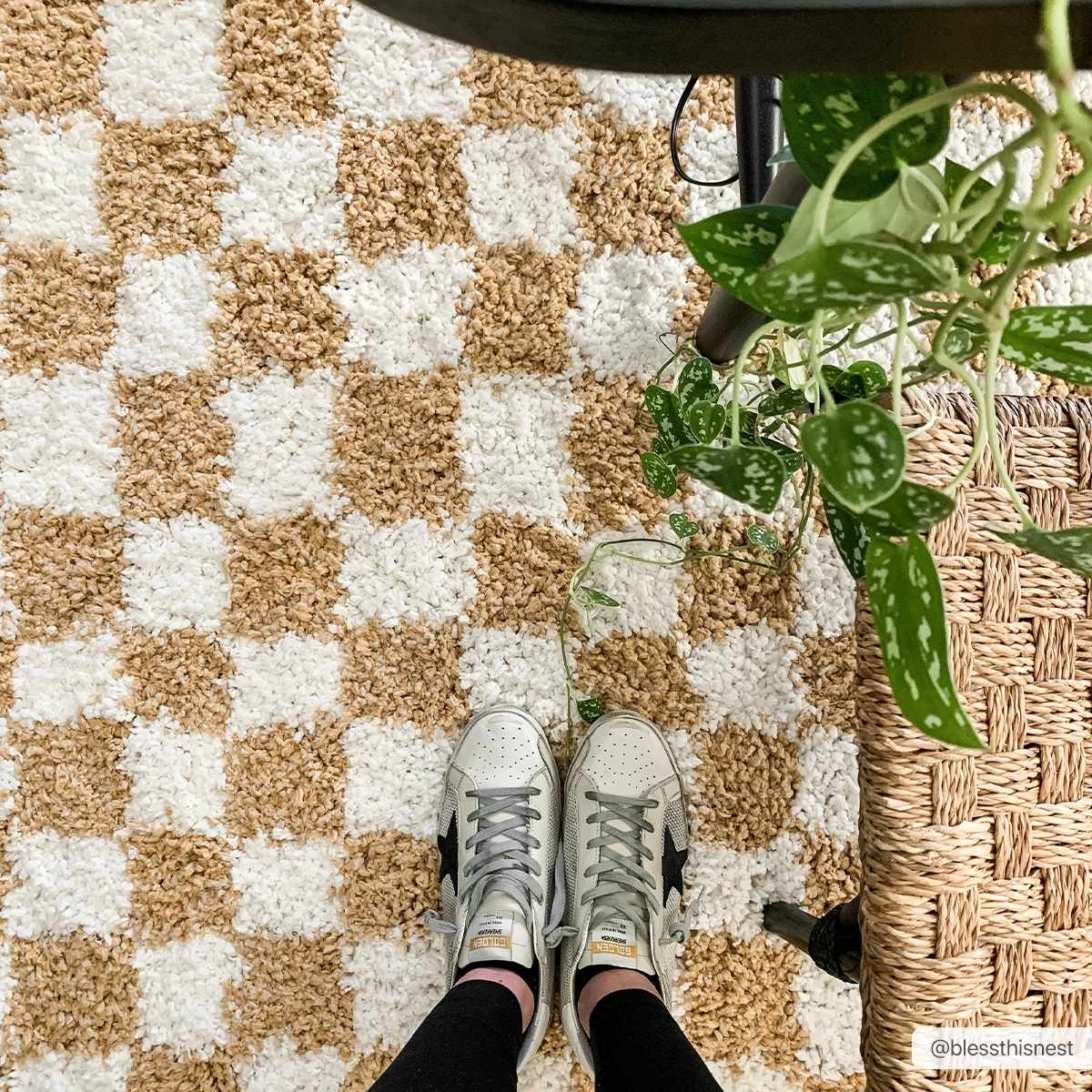 Close-up of the shaggy Kieu Mustard & Ivory Checkered Area Rug, with a checkered pattern and neutral tones. Roomscene-Rectangle
