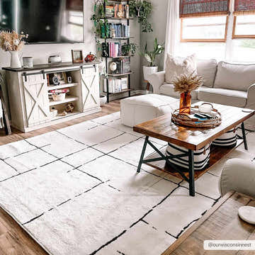 Living room scene with beige Koume Maze Area Rug, white sofa, wood coffee table, and farmhouse decor. Roomscene-Rectangle