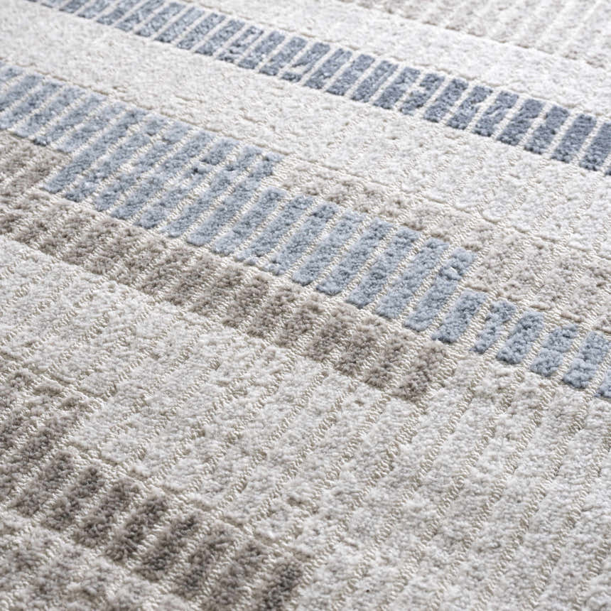 Close-up of the Brisa Area Rug showing its textured, machine-woven design with blue and gray stripes. Texture