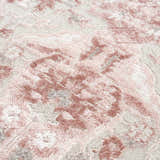 Close-up of the Zora Pink Area Rug showing its traditional floral pattern and soft pink and gray hues. Texture