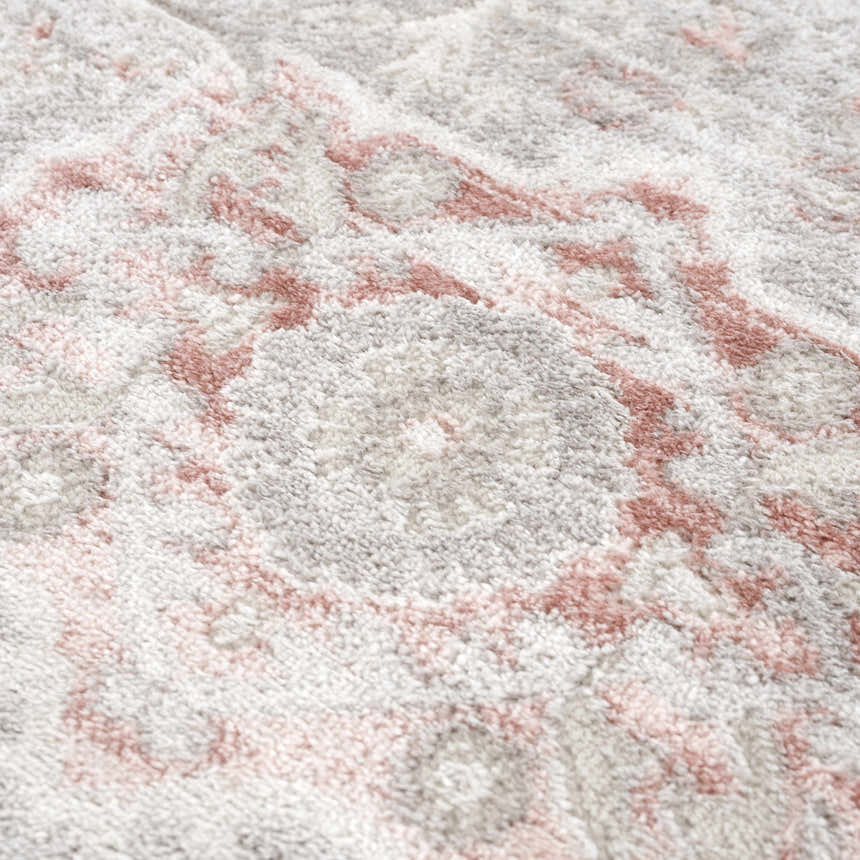 Close-up of the Damla Area Rug showing its plush texture and vintage-inspired pink and gray floral pattern. Texture