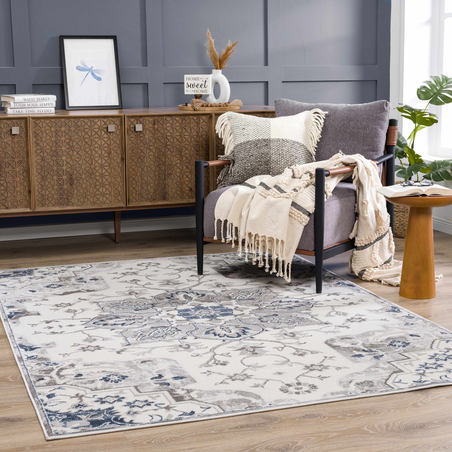 Living room scene with Calum Blue & Gray Area Rug, gray accent wall, wood cabinet, and armchair with throw. Roomscene-Rectangle