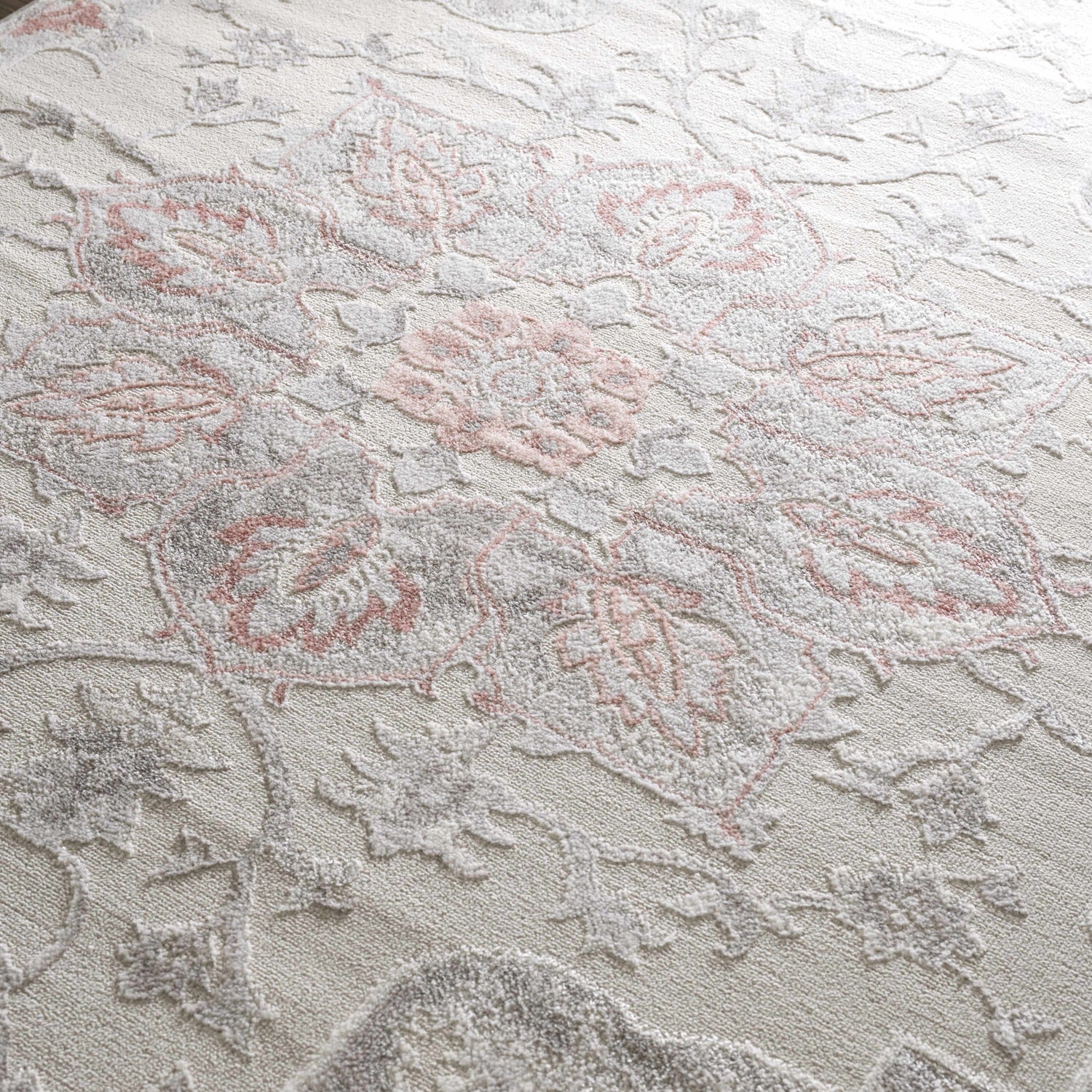 Close-up of the Calum Pink Floral Area Rug showing its texture and gray and pink traditional floral design. Texture