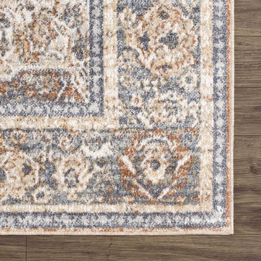 Close-up of the Arias Blue Boutique Washable Rug, showcasing its traditional pattern, faded driftwood, clay, and blue tones. Swatch