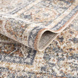 Close-up of the Arias Blue Boutique Washable Rug showing the traditional pattern, soft texture, and blended beachhouse colors. Fold