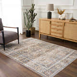 Living room scene with a vintage Arias Blue Boutique Washable Rug, gray chair, and wood cabinet. Roomscene-Rectangle