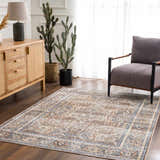 Living room scene with the Arias Blue Boutique Washable Rug, wood cabinet, gray chair, and cacti. Farmhouse style. Roomscene-Rectangle