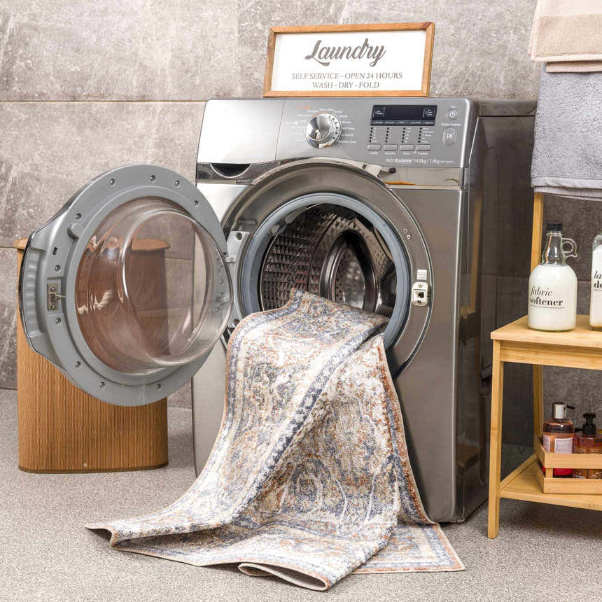 Arias Blue Boutique Washable Rug being washed in a laundry room scene. Farmhouse style, oriental pattern rug. Washing-Machine