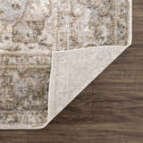 Close-up of the Gael Boutique Washable Rug showing the vintage tan, olive, and light blue pattern and rug backing. Fold
