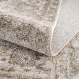 Close-up of the Gael Boutique Washable Rug showing its texture, neutral color palette, and vintage-inspired pattern. Fold
