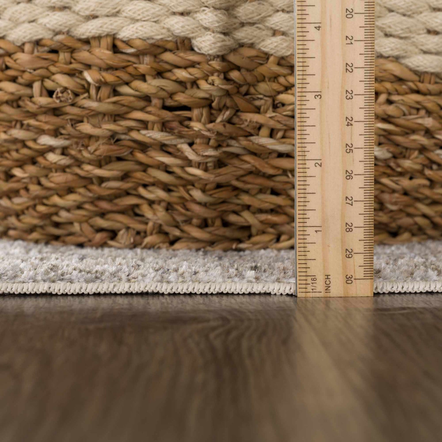 Close-up of the Gael Boutique Washable Rug showing the rug's edge, pile height, and woven texture against a wood floor. Pile