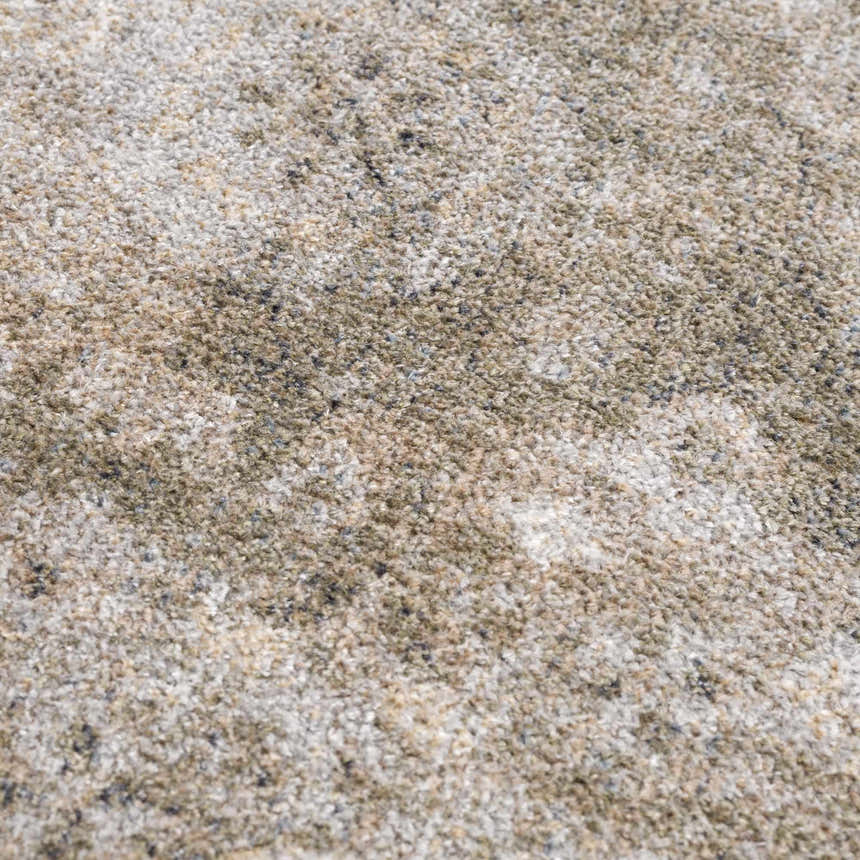 Close-up of the Gael Boutique Washable Rug. Neutral tones of tan, olive, and light blue create a vintage, textured pattern. Texture