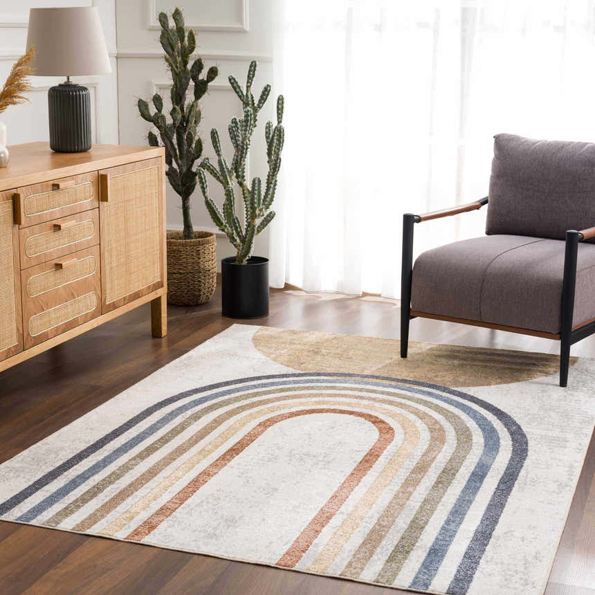 Living room with a Giza Washable Area Rug in a rainbow pattern, gray armchair, and wooden cabinet. Roomscene-Rectangle