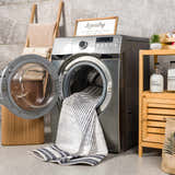 Laundry room scene with a Thad Medium Gray Washable Area Rug being washed in a front load washing machine. Washing-Machine
