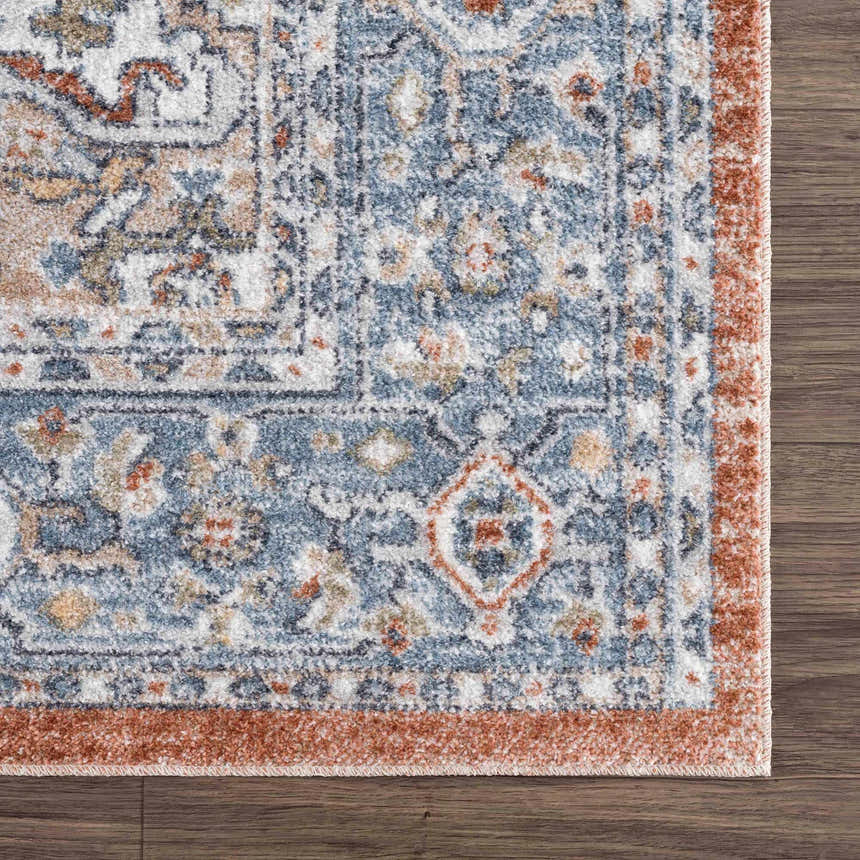 Close-up of Ember Washable Area Rug in Beachhouse: traditional, farmhouse style with blue, white, and copper tones. Swatch
