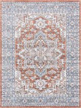 Close-up of Ember Washable Area Rug in beachhouse, charcoal, and copper. Traditional style with a detailed, symmetrical pattern. Design-Rectangle-5373