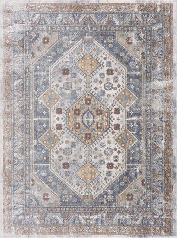 Close-up of the Afya Boutique Washable Rug. Traditional style rug in beige, blue, rust, and tan with a distressed geometric pattern. Design-Rectangle-5373
