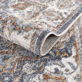 Close-up of Aurum Blue & Beige Washable Area Rug, showing traditional pattern, texture, and colors. Fold