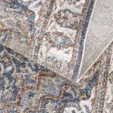 Close-up of Aurum Blue & Beige Washable Area Rug, showcasing its traditional pattern, texture, and colors. Clearance rug. Fold