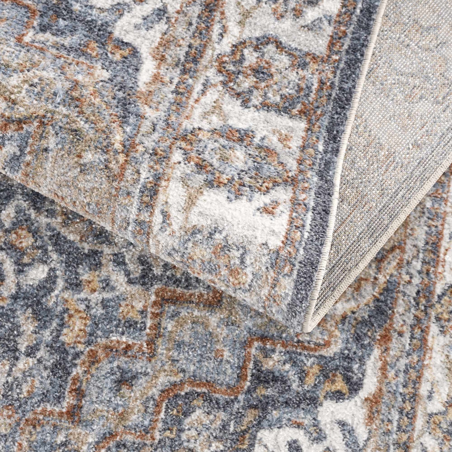 Close-up of Aurum Blue & Beige Washable Area Rug, showcasing its traditional pattern, texture, and colors. Clearance rug. Fold