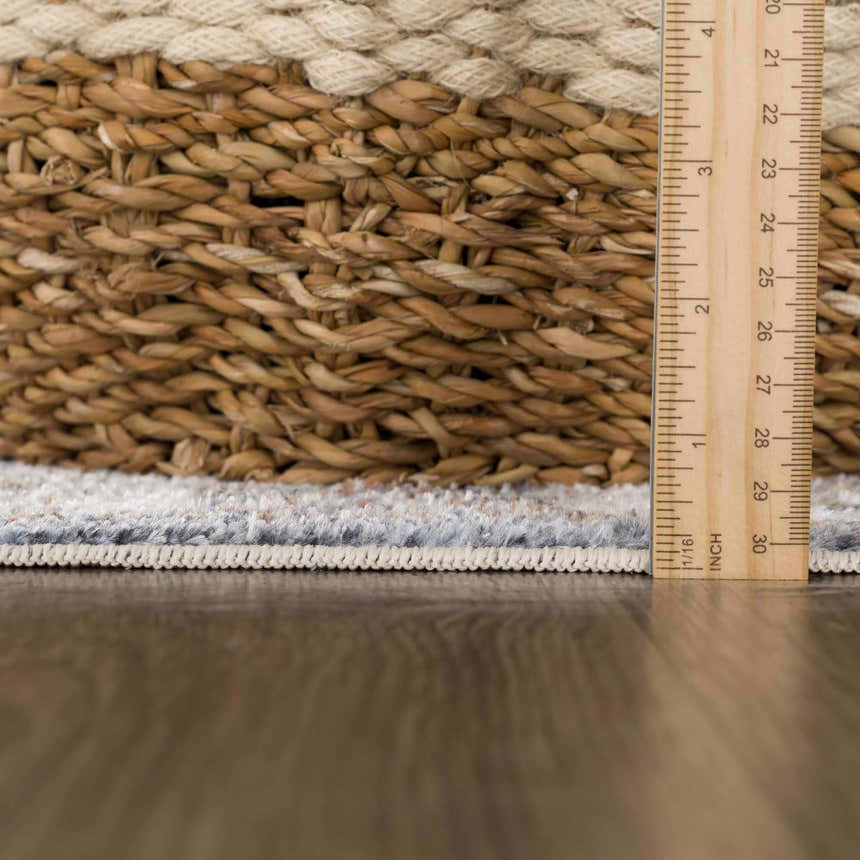 Close-up of Aurum Blue & Beige Washable Area Rug showing texture, design, and pile height with a ruler for scale. Pile