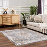 Living room with Aurum Blue & Beige Washable Area Rug, wood cabinet, and neutral sofa. Farmhouse style. Roomscene-Rectangle