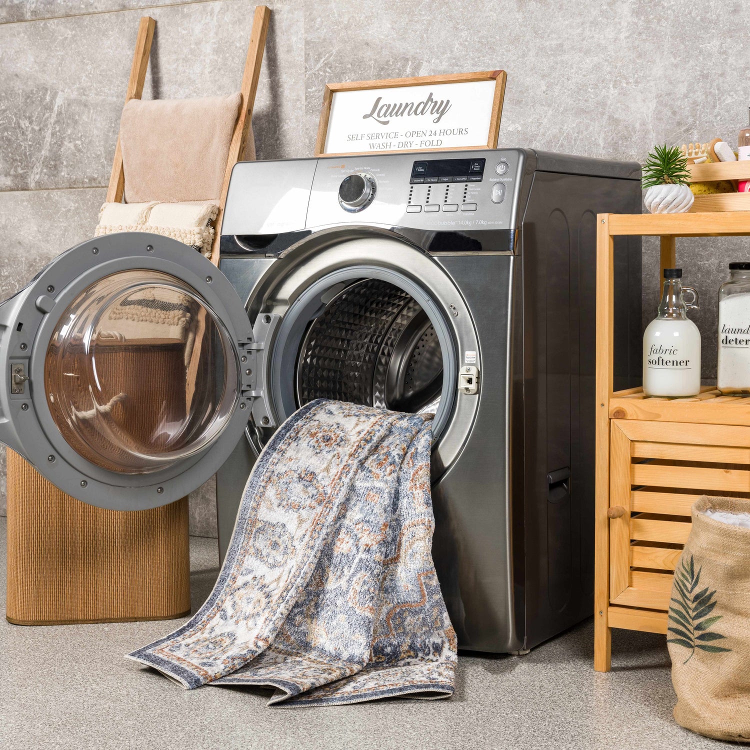 Laundry room scene with Aurum Blue & Beige Washable Area Rug partially inside a washing machine. Farmhouse style decor. Washing-Machine