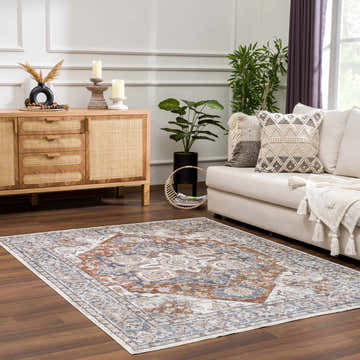 Living room with a beige sofa and the blue and rust Erna Washable Area Rug. Roomscene-Rectangle