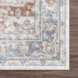 Close-up of the Neta Red & Blue Flat Pile Washable Rug. Features a traditional oriental pattern in red, blue, and nutmeg tones. Swatch