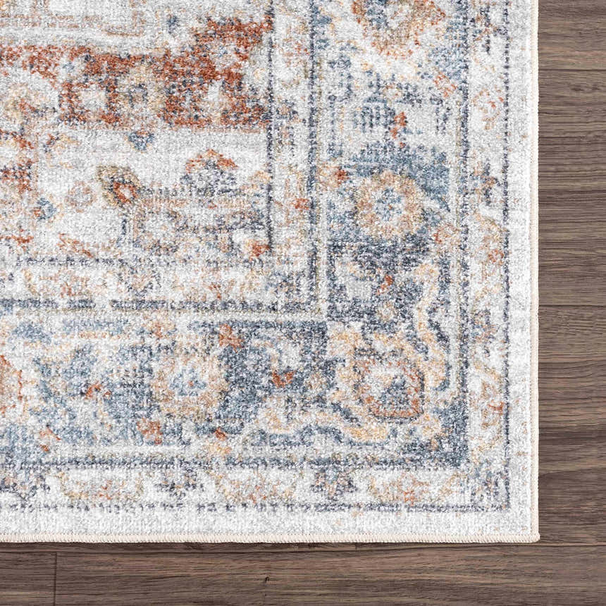 Close-up of the Neta Red & Blue Flat Pile Washable Rug. Features a traditional oriental pattern in red, blue, and nutmeg tones. Swatch