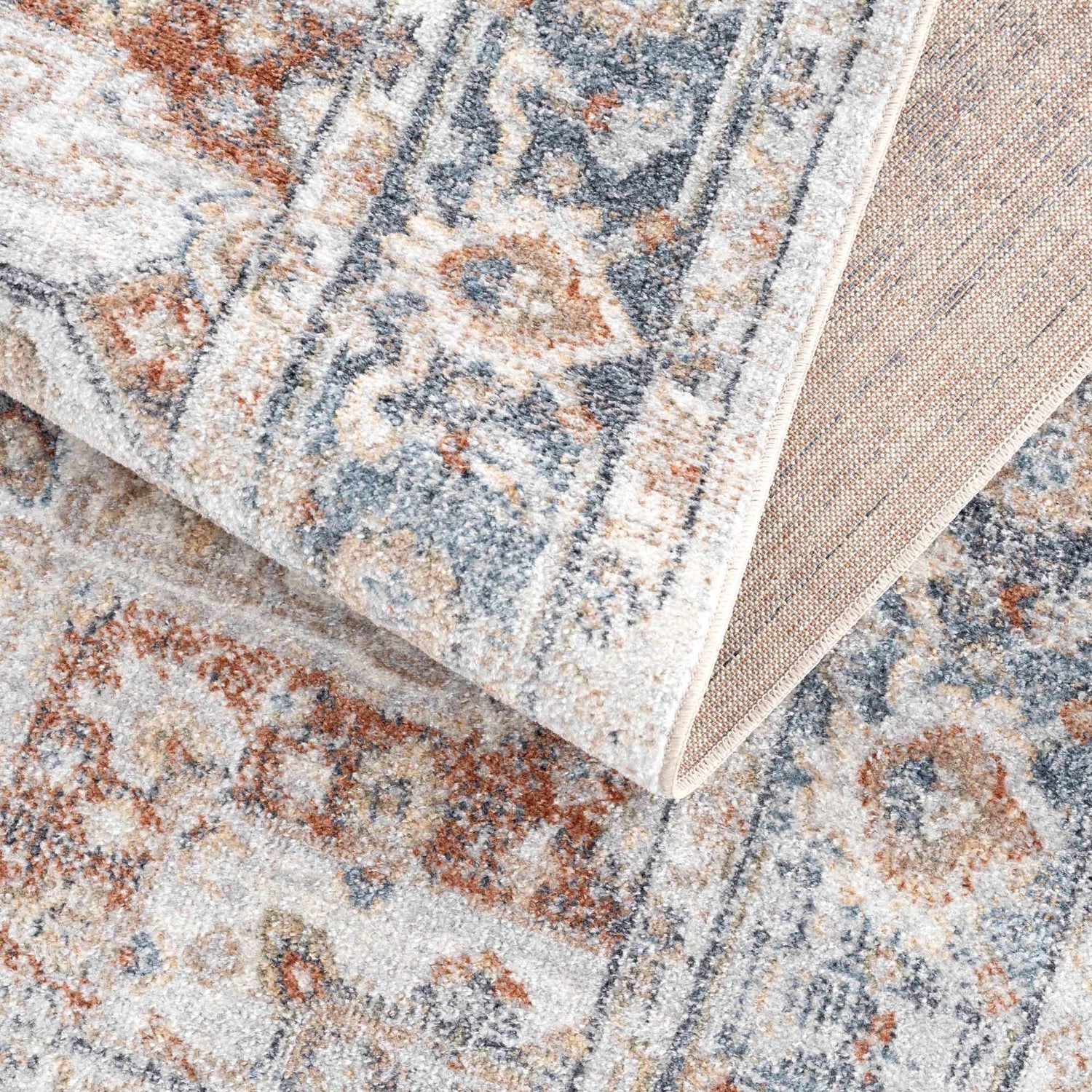 Close-up of the Neta Red & Blue Flat Pile Washable Rug showing its traditional, vintage pattern and flat weave texture. Fold