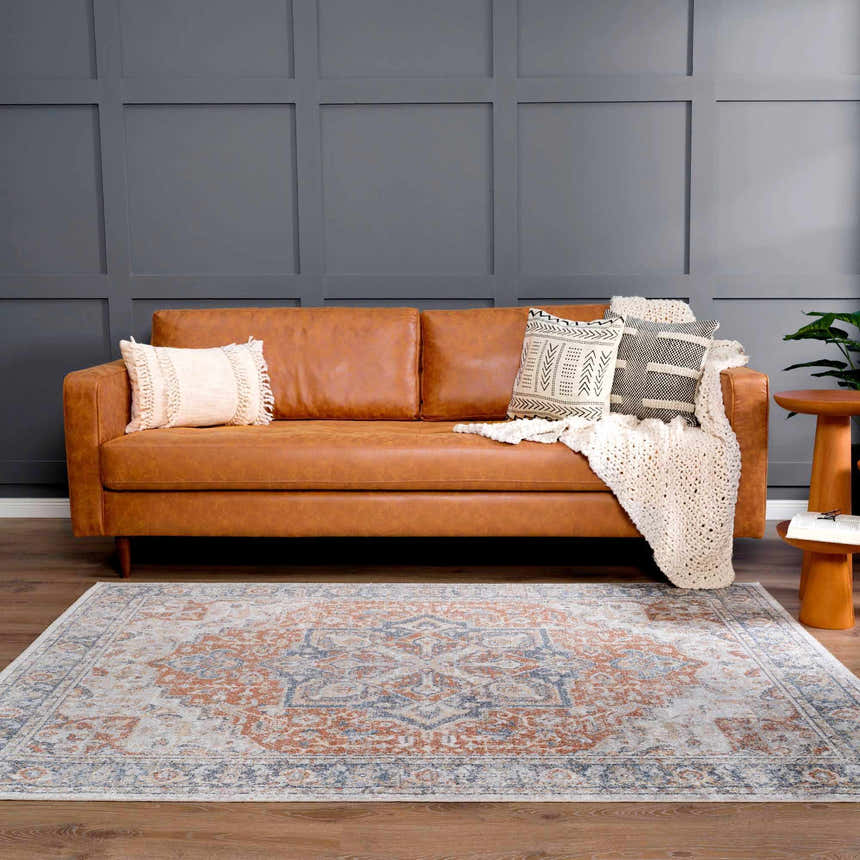 Living room scene with a Neta Red & Blue washable rug, brown leather sofa, and gray accent wall. Farmhouse style. Roomscene-Rectangle