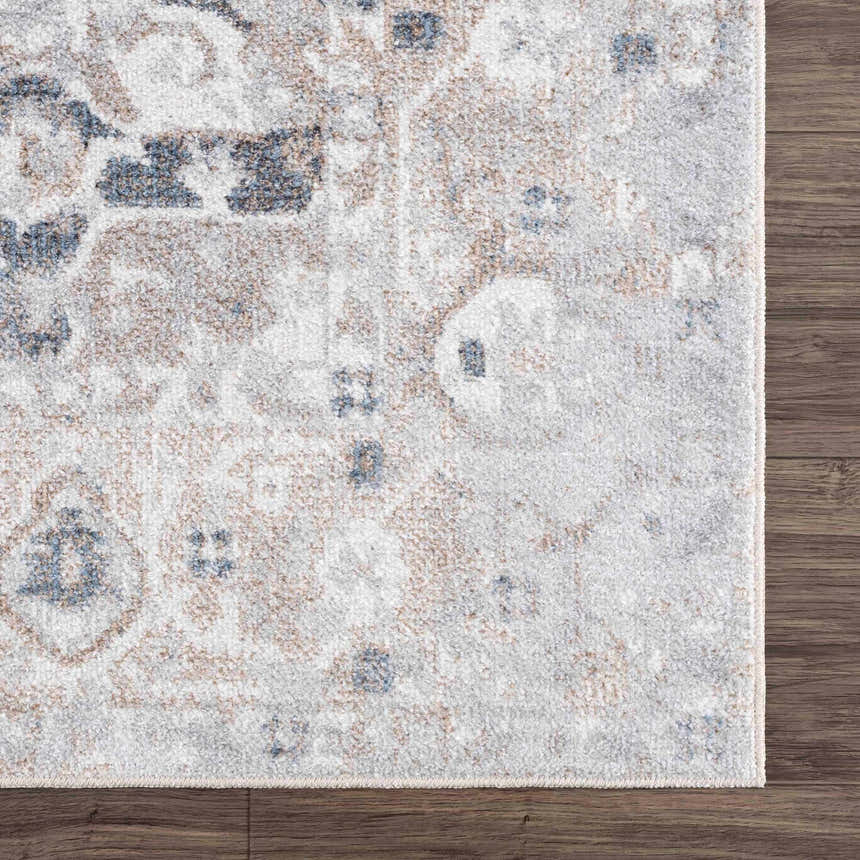 Close-up of the Dobry Boutique Washable Rug. Features blue, tan, and off-white oriental pattern on a textured polyester rug. Swatch
