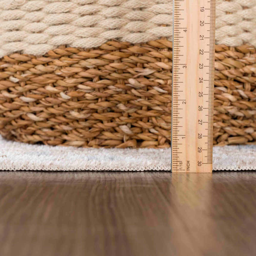 Close up of the Dobry Boutique Washable Rug showing texture, off white, tan, and brown colors. Ruler for scale. Pile