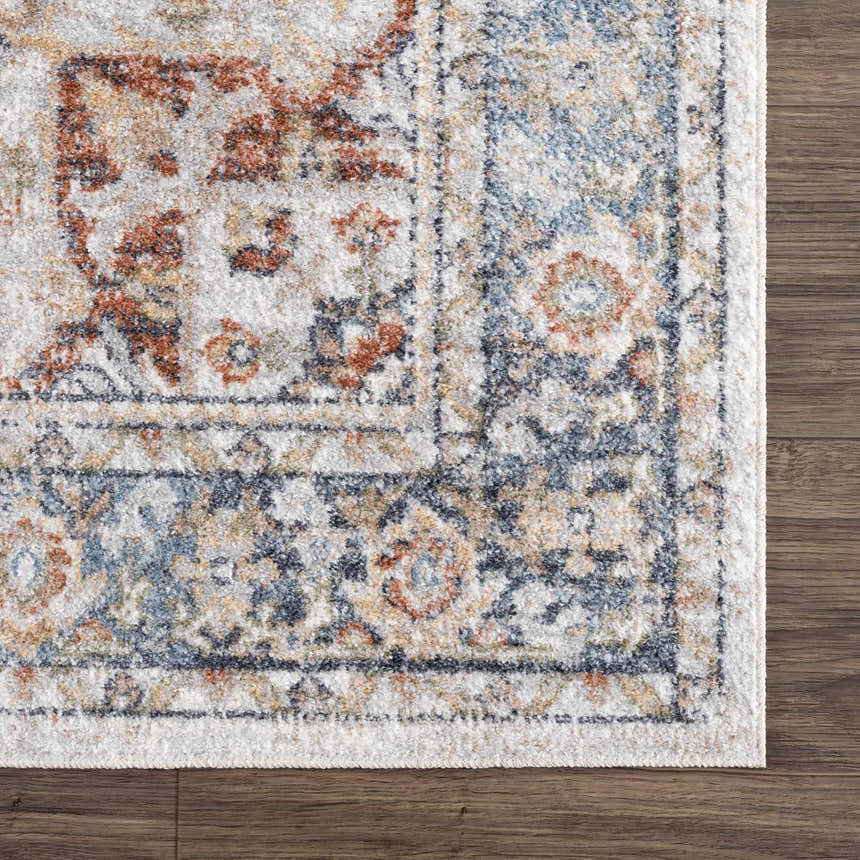 Close-up of the Akram Gray & Orange Washable Area Rug, showing its traditional vintage design and soft polyester texture. Swatch