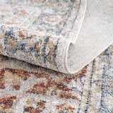 Close-up of the Akram Gray & Orange Washable Area Rug showing its traditional vintage pattern and soft polyester texture. Fold