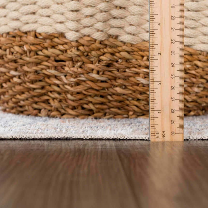 Close-up of Akram Gray & Orange Washable Area Rug showing pile height and texture with a ruler for scale. Pile