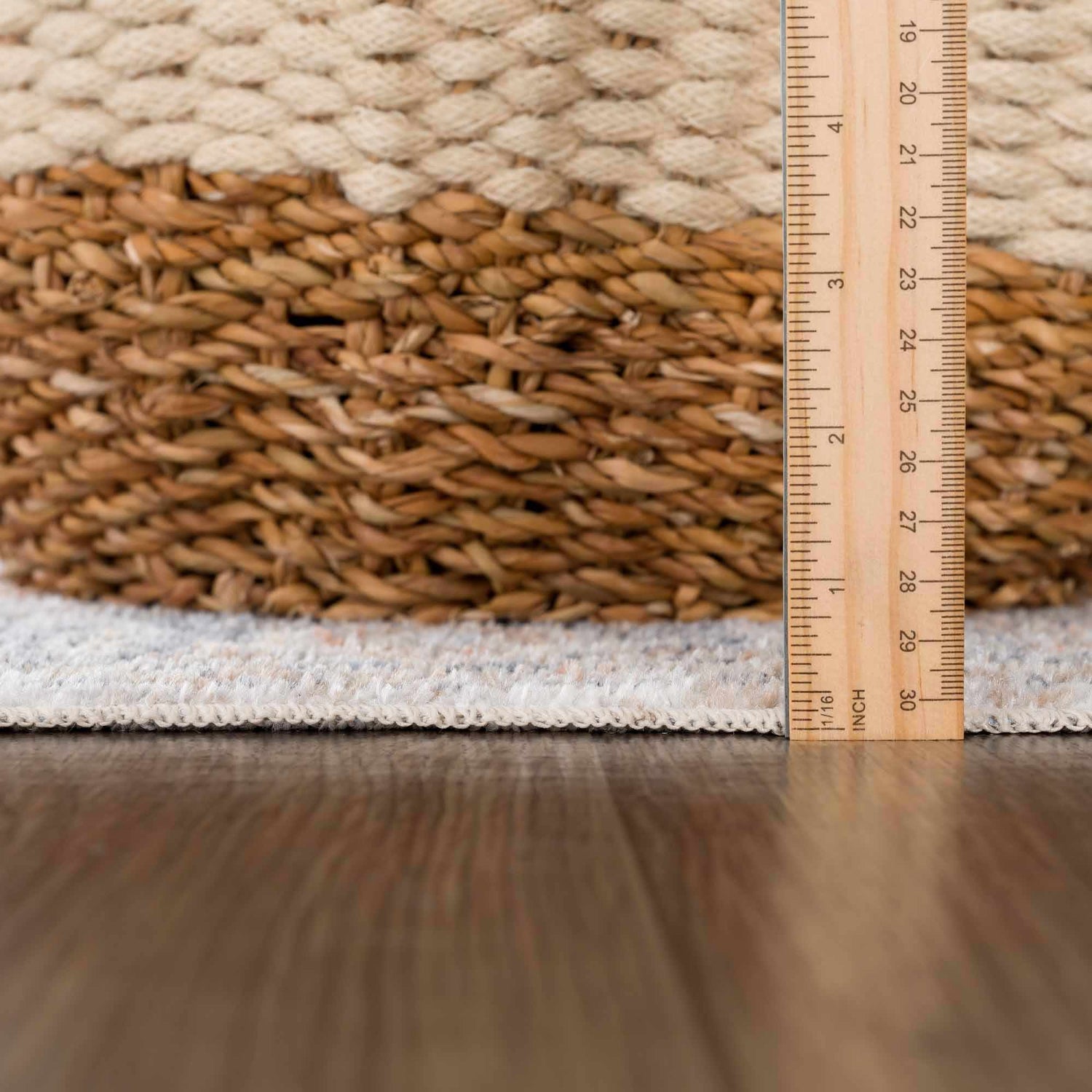 Close-up of Akram Gray & Orange Washable Area Rug showing pile height and texture with a ruler for scale. Pile
