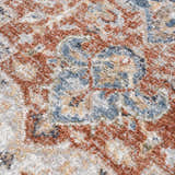 Close-up of the Akram Gray & Orange Washable Area Rug showing its traditional, vintage-inspired pattern and soft polyester texture. Texture