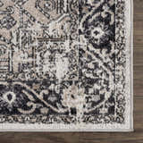 Close-up of the Cabacungan Washable Area Rug. Black, gray, light beige, and taupe vintage-style pattern. Swatch