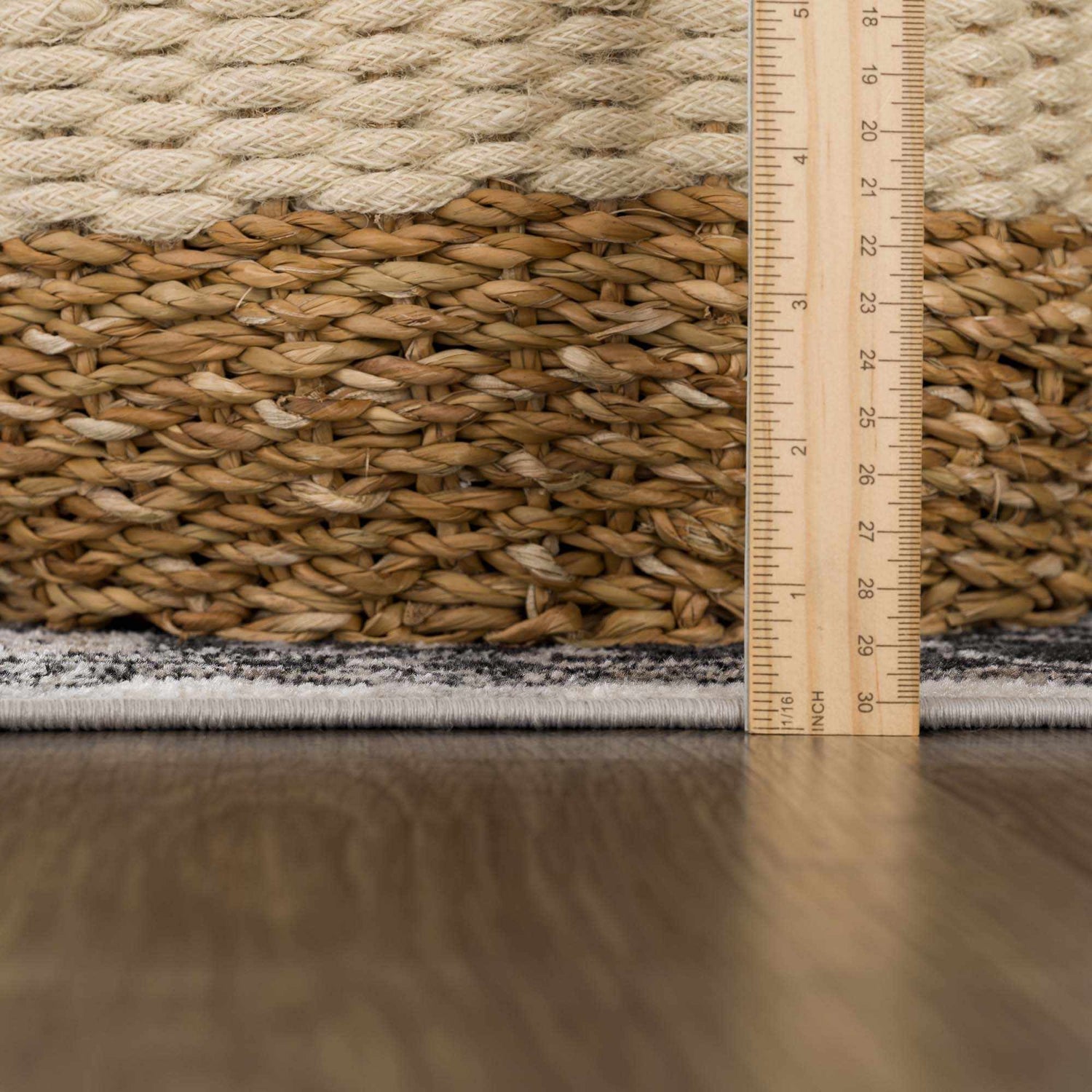 Close up of Cabacungan Washable Area Rug showing gray, light beige colors and texture with ruler for scale. Pile