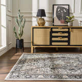Living room scene with a black, gray, and beige Cabacungan Washable Area Rug, wood floors, and a modern cabinet. Roomscene-Rectangle